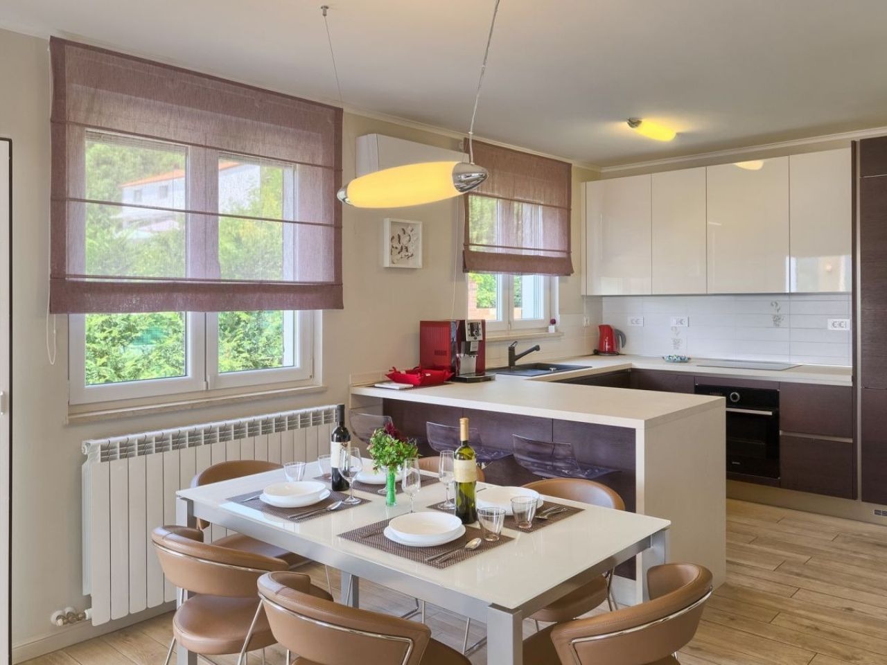 Modern kitchen with breakfast bar and set dining table