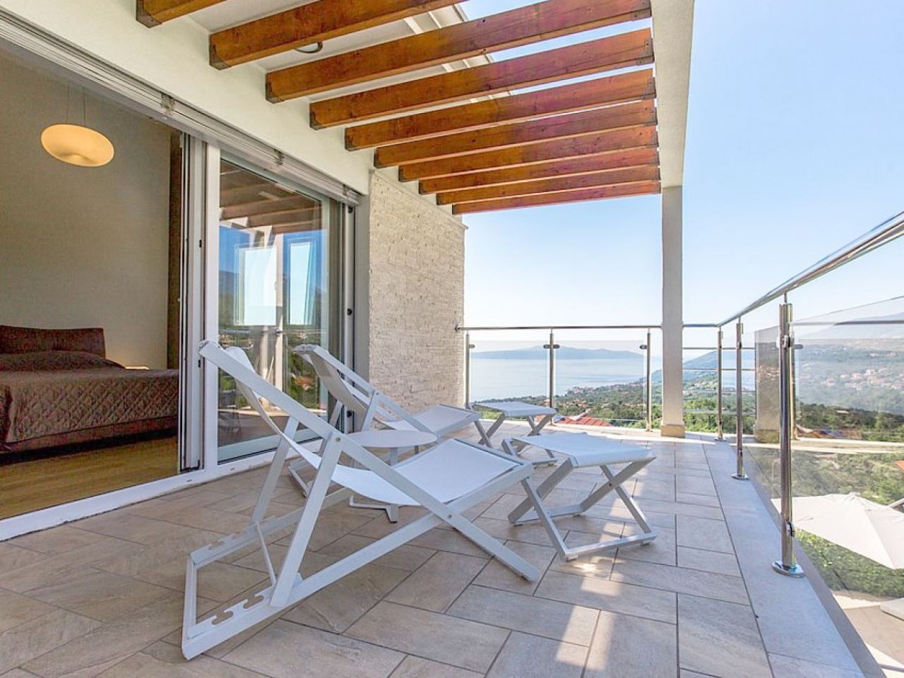 Bedroom terrace with sun loungers and panoramic sea views