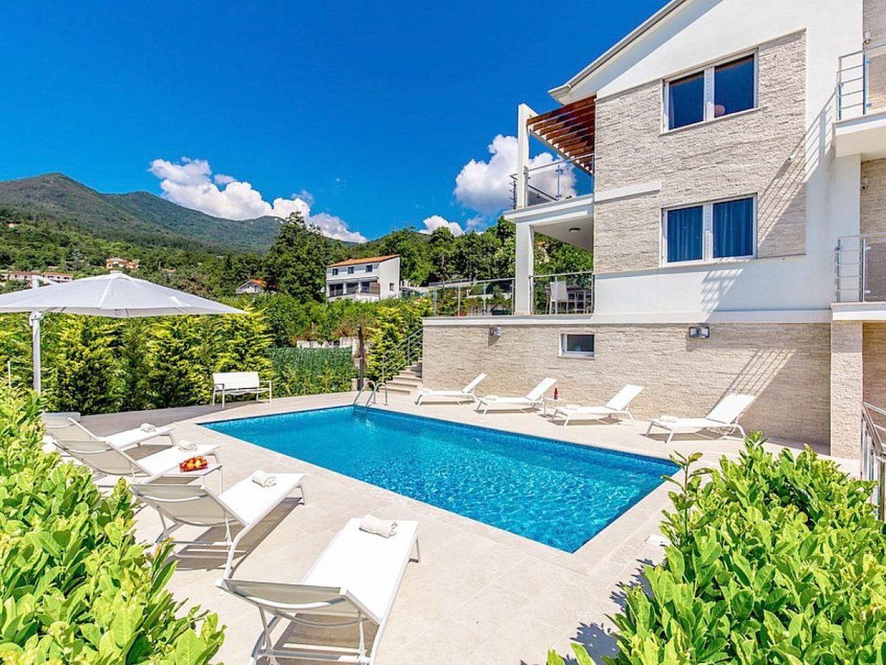 Outdoor pool and Villa Edelweiss façade