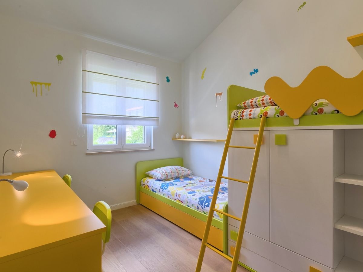 Children’s bedroom with bunk bed, single bed and study desk
